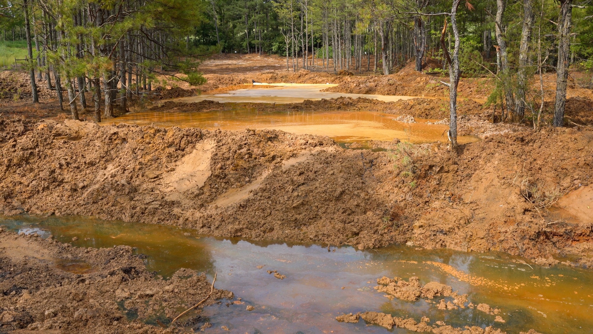 Davis Mill Creek runs through the Copperhill mine site, picking up acid mine drainage before entering a water treatment plant and then the Ocoee River.