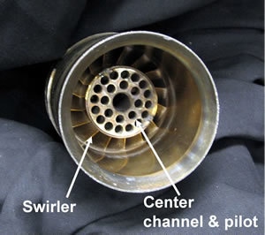 The figure demonstrates a prototype of the low-swirl injector. Fuel flows through the openings of the center channel. This simple design creates the low-swirl flow, with lower emissions of NOx as the result of this process.