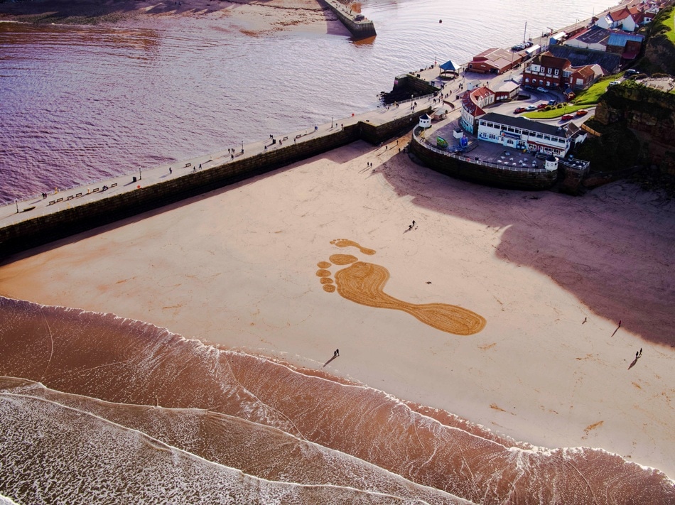 Giant Footprints Appear on Whitby Bay to Highlight the Carbon Footprint of Our Vehicles